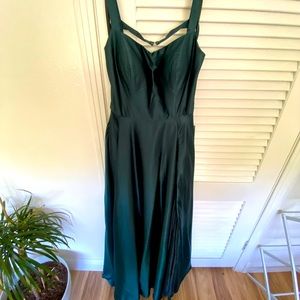 Beautiful emerald green semi formal gown with slit. Never worn, new with tags.